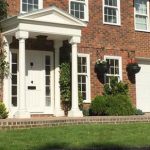 Large home with sliding sash windows and porch