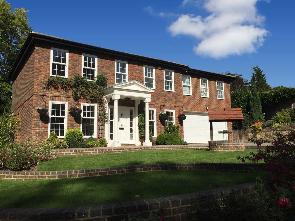 Large home with sliding sash windows and porch