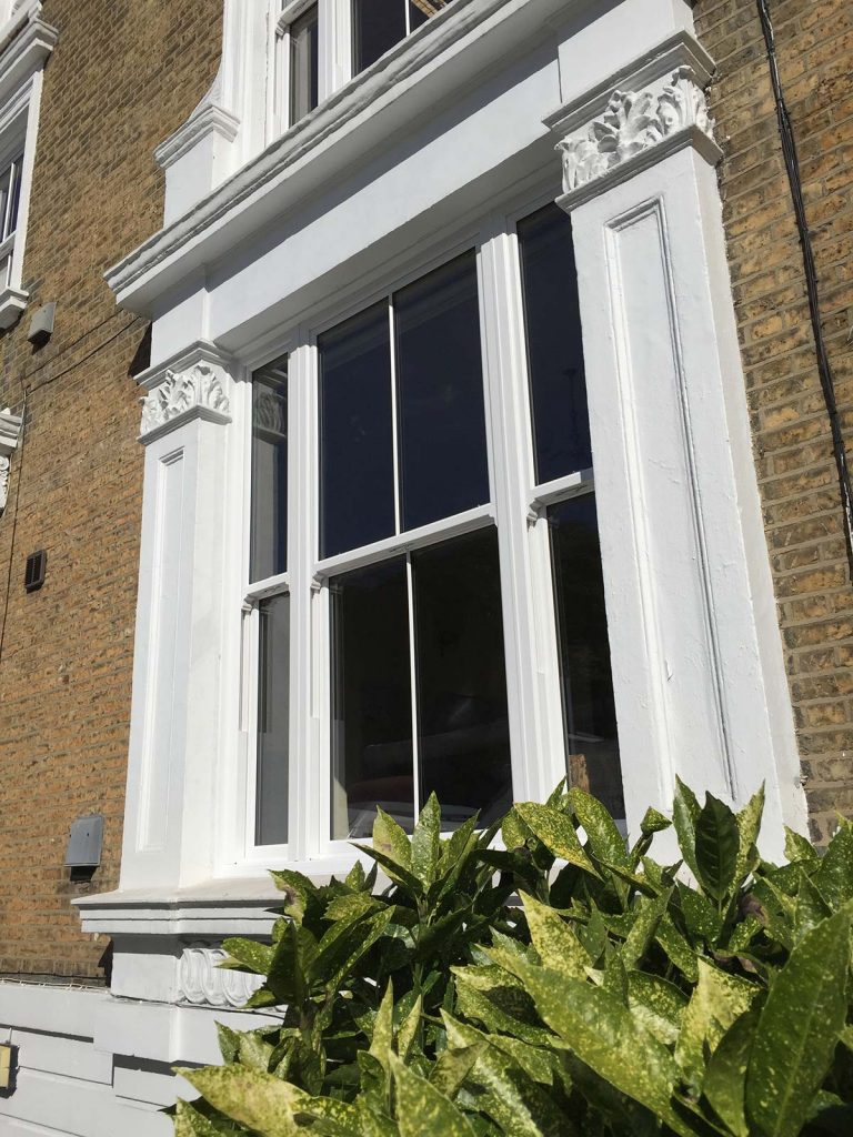 Victorian sash window in brick home 